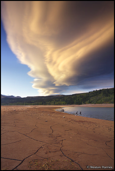 - Unusual Lenticular Cloud Formations Above the Cracked Shoreline of Two Medicine Lake at Sunset, Glacier NP -