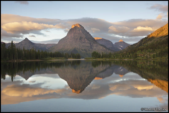 - Painted Teepee Peak, Mt. Sinopah, and Mt. Helen Reflected in Upper Two Medicine Lake at Sunrise, Glacier NP -