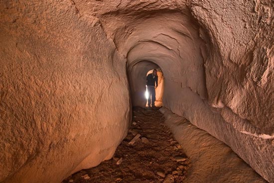 - A Hiker Inside The Tunnel, a 60 ft. Long Narrow Arch, Arches NP -