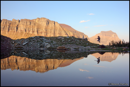 - Hiker Jumping, Reflected in a Pond at Logan Pass, Glacier NP -