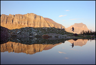 - Hiker Jumping, Reflected in a Pond at Logan Pass, Glacier NP -