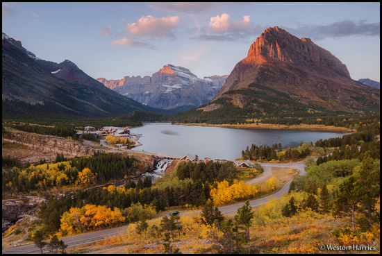 - First Light on Mt. Gould and Grinnell Point, with Swiftcurrent Lake,
Many Glacier Hotel and Aspens in Fall Color Below, Glacier NP -